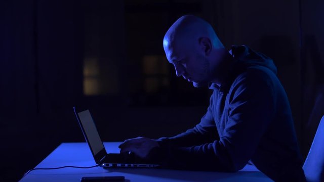 hacker using laptop computer for cyber attack