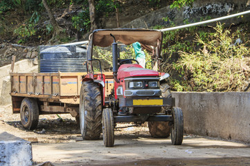 Old tractor with a trailer at a water pipeline construction