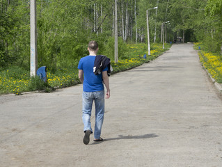 man traveler with a backpack running on the road