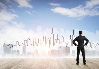 Motivation and inspiration concept with modern cityscape and businessman observing it