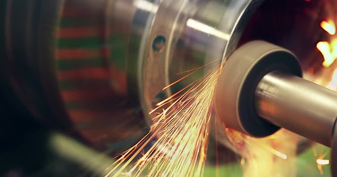 sparks flying while machine griding and finishing metal