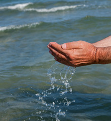 Fototapeta na wymiar Photo of hands with sea water.