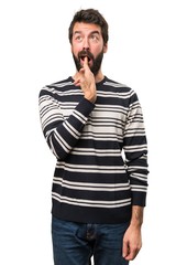 Man with beard making suicide gesture