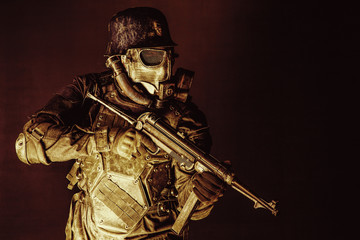 Futuristic nazi soldier gas mask and steel helmet with schmeisser handgun black background studio...