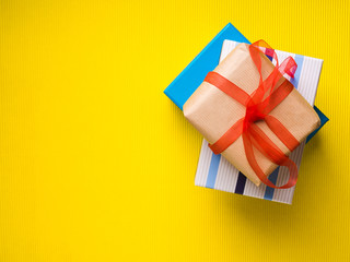 Blue Gift boxes stack on vibrant yellow background. Christmas fathers day shopping