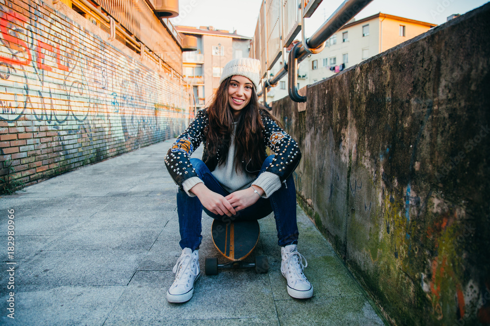 Wall mural skater woman sitting on longboard