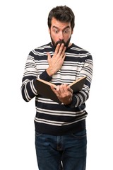 Surprised Man with beard reading a book