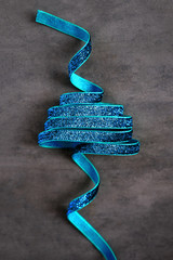 Glitter ribbon in shape of Christmas tree on dark