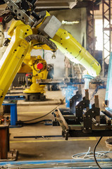 Fototapeta premium Welding robot in operation / Photo taken in Russia, in factory premises