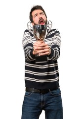 Man with beard holding a trophy