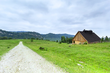 Fototapeta na wymiar Beautiful scenery of Tatra mountains with wooden hut in Poland