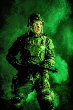 Ugly face of Futuristic nazi soldier in gas mask and steel helmet. Skin burned by atomic flame
