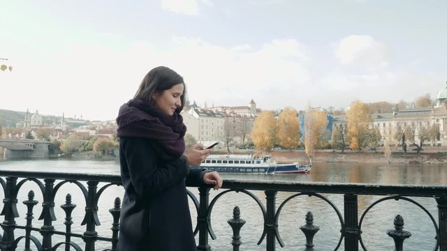 Beautiful Young Woman Tourist In Prague Using Her Smartphone, Travelling Concept