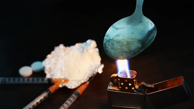 preparation of narcotic substance in the spoon on fire