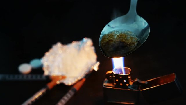 preparation of narcotic substance in the spoon on fire