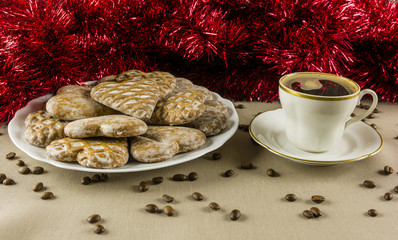 Heart-shaped gingerbread and white coffee with hot coffee.