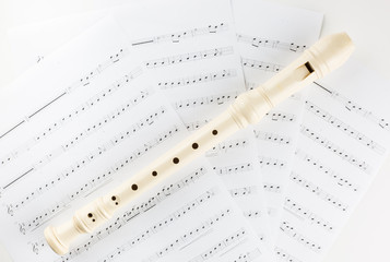 Fototapeta premium Close-up of flute with notes on the white background