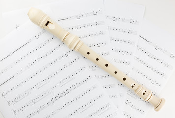 Fototapeta premium Close-up of flute with notes on the white background