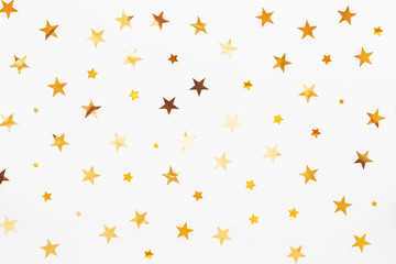 Holiday background with golden star confetti. Good background for Christmas and New Year cards.