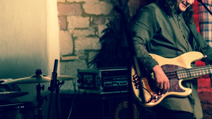 bass player having fun playing a live show with his band