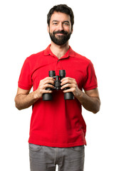 Fototapeta na wymiar Happy Handsome man with binoculars