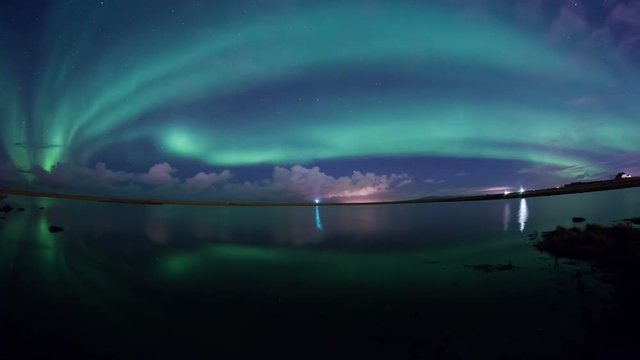 Aurora borealis accross whole sky reflecting calm water lake Grotta lighthouse Iceland 4k.mov