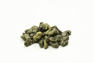 rolled green tea leaves on a white background