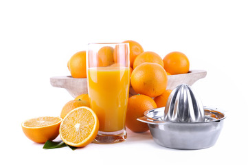glass of orange juice with fruit and press citrus on white background