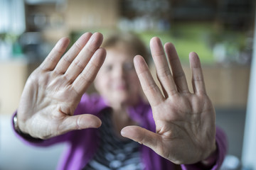 old woman with stop gesture - selective focus on hands - obrazy, fototapety, plakaty