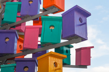Colorful nesting boxes over blue sky background and