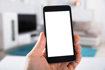 Person Holding Smartphone With Blank White Screen