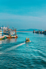 Obraz premium Chumphon, Thailand - 9 February 2014: Fishing boats at the coastal fishing villages. Preparation sea fishing. entering the sea along the pier