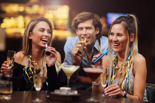 Group Of Friends Enjoying Drink in Bar