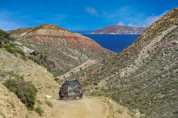 jeep car in baja california landscape panorama desert road with cortez sea on background © Andrea Izzotti