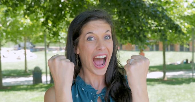 Excited happy woman shouting yeah and clenching her fists