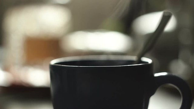 Cup of hot coffee or tea with steam coming from it