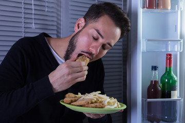 Young Man Eating Fried Food