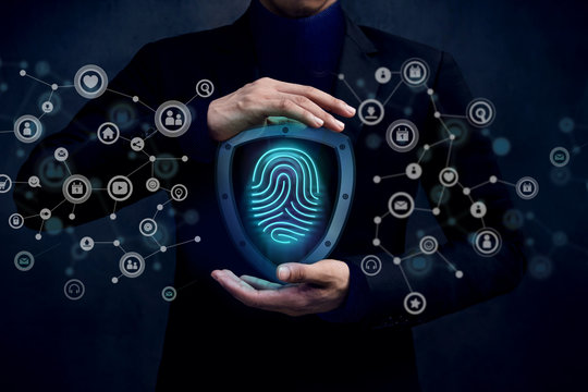 Network Security System Concept, Fingerprint inside a Shield Guard to Protected Identify or Personal Information from Cyber Attacks, Present over Businessman Hand and Social Media icons