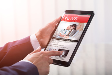 Close-up Of A Businessperson Holding Tablet