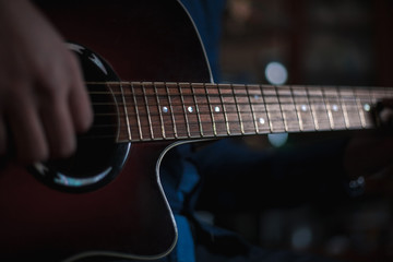 Obraz na płótnie Canvas the guy playing the acoustic guitar, closeup, music concept