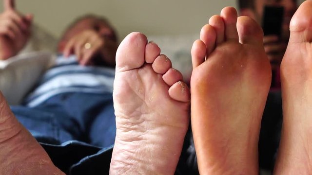 Feet of Friends/Father and Son playing on the bed