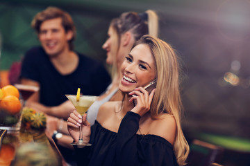 Group Of Friends Enjoying Drink in Bar