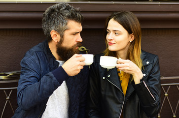 Portrait of lovely romantic couple sitting in a cafe