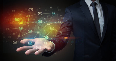 Businessman holding communication symbols