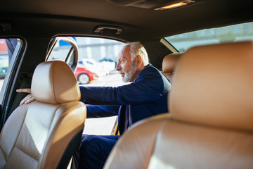 Senior business man in his limousine. Business concept.