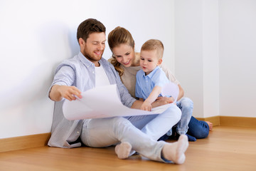 happy family with blueprint moving to new home
