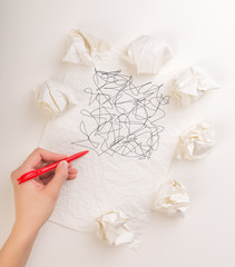 Writing hand in crumpled paper