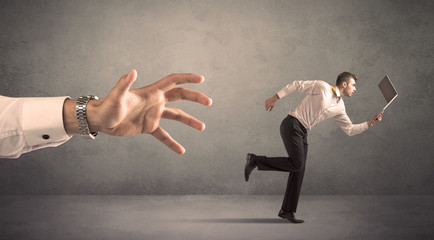 Businessman running from hand