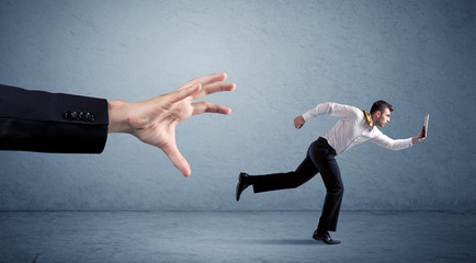 Businessman running from hand