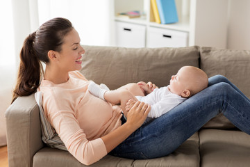 happy mother with little baby boy at home